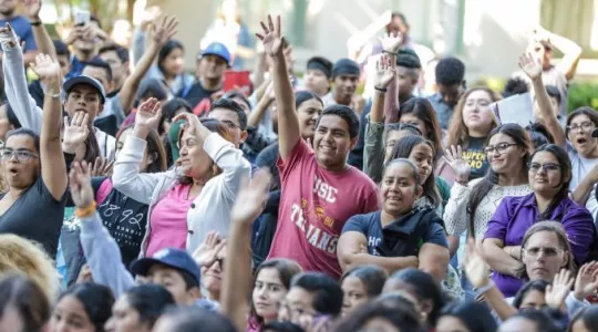 group of people with hands up