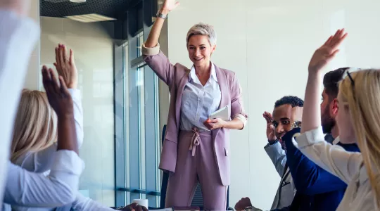 Boss and employees raising hands